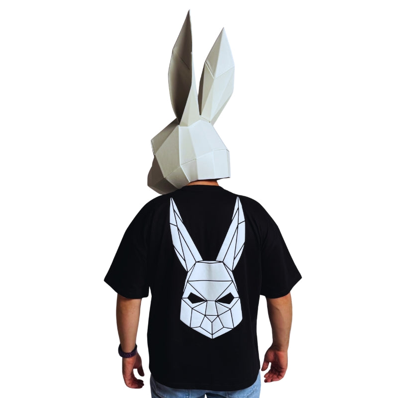 The Magician wearing a black t-shirt with The Magician's geometric rabbit mask on the back.