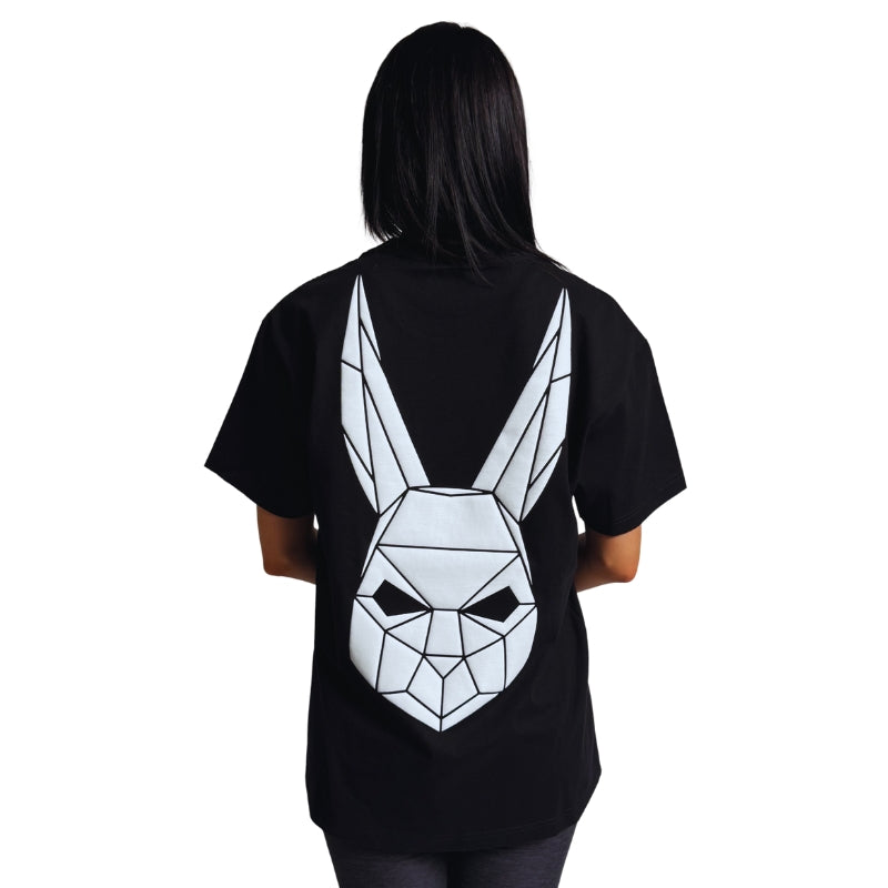 Model wearing a black t-shirt with The Magician's geometric rabbit mask on the back.