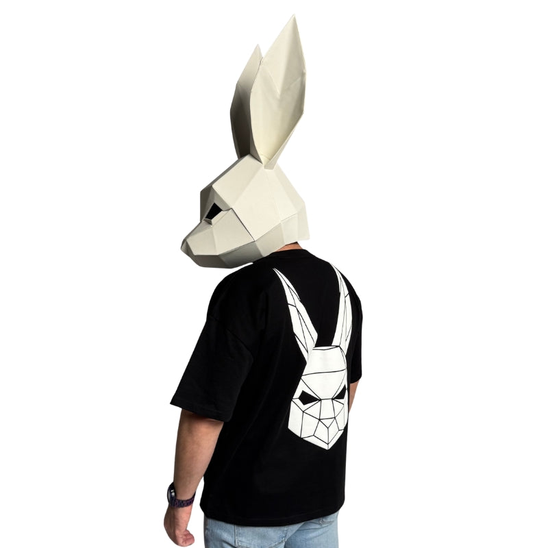 The Magician wearing a black t-shirt with The Magician's geometric rabbit mask on the back.