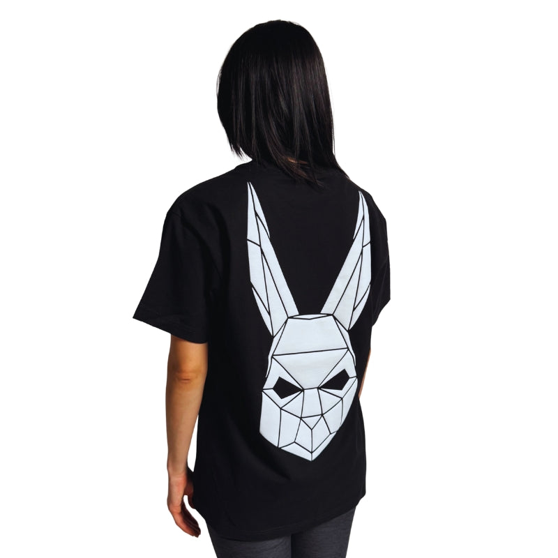 Model wearing a black t-shirt with The Magician's geometric rabbit mask on the back.